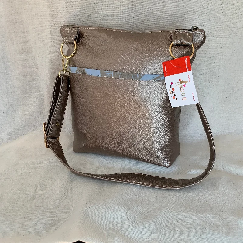 Top Brand Discounts Metallic vinyl crossbody with exterior slip pockets and interior zip pockets.