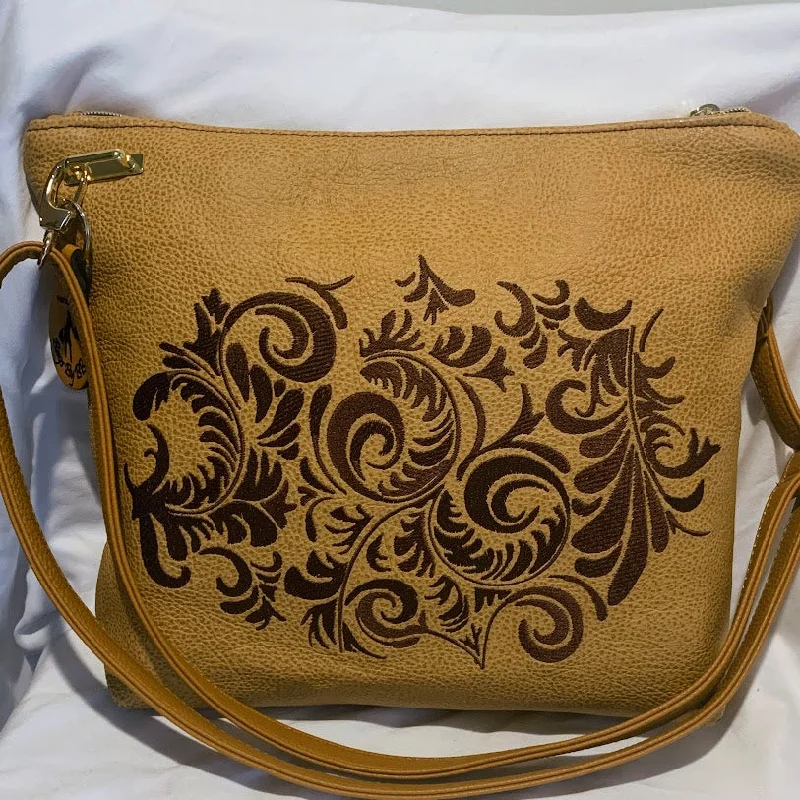 Bags With Tsa-Approved Features Beautiful crossbody of caramel colored Italian leather with embroidery