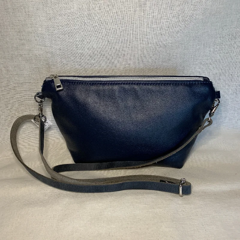 Vintage-Inspired Style Offers Navy blue leather mini crossbody with interior zipper pockets.